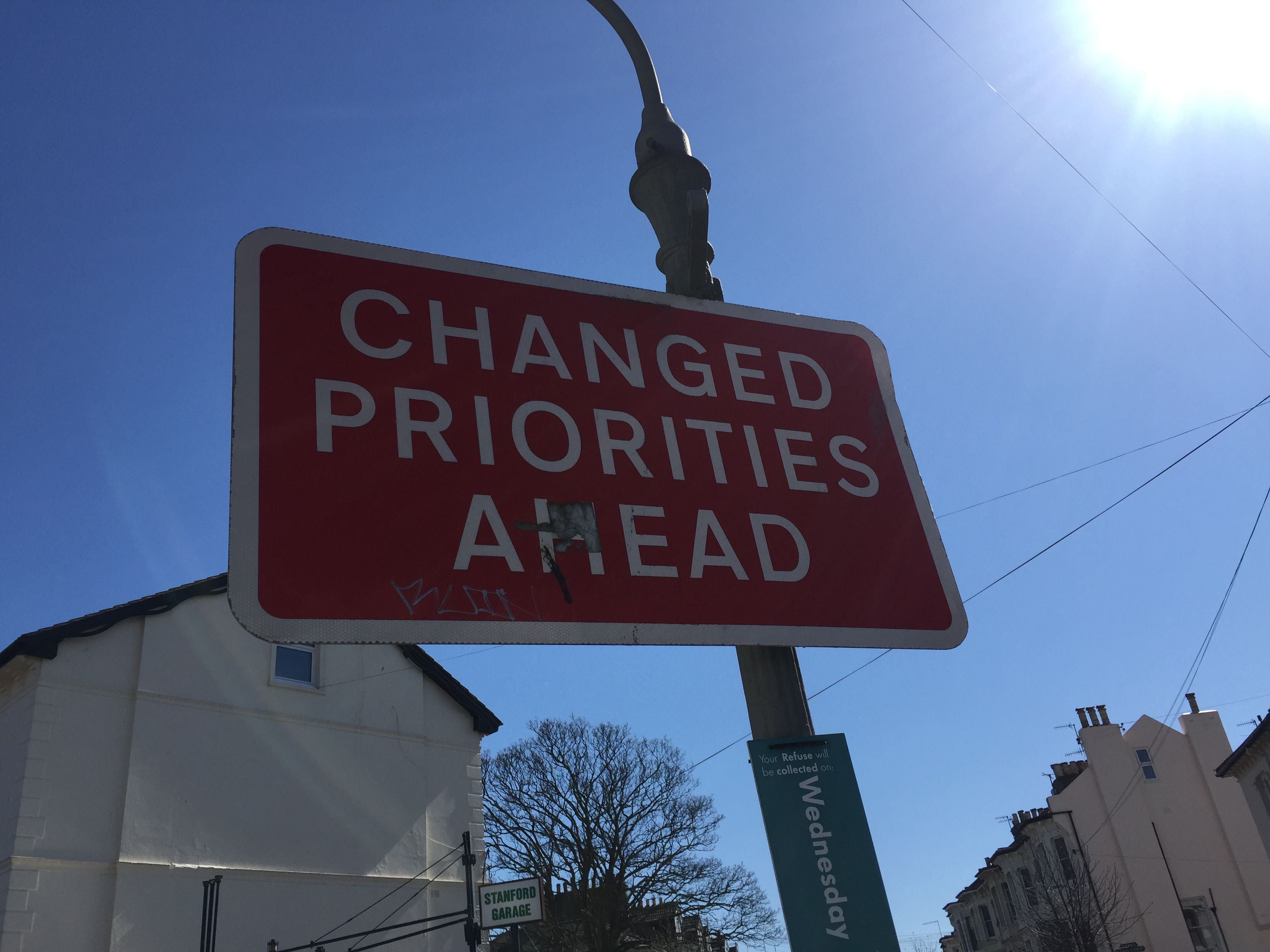 Photo of a road sign which says CHANGED PRIORITIES AHEAD